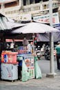 Bustling Street Market Stall with Umbrella