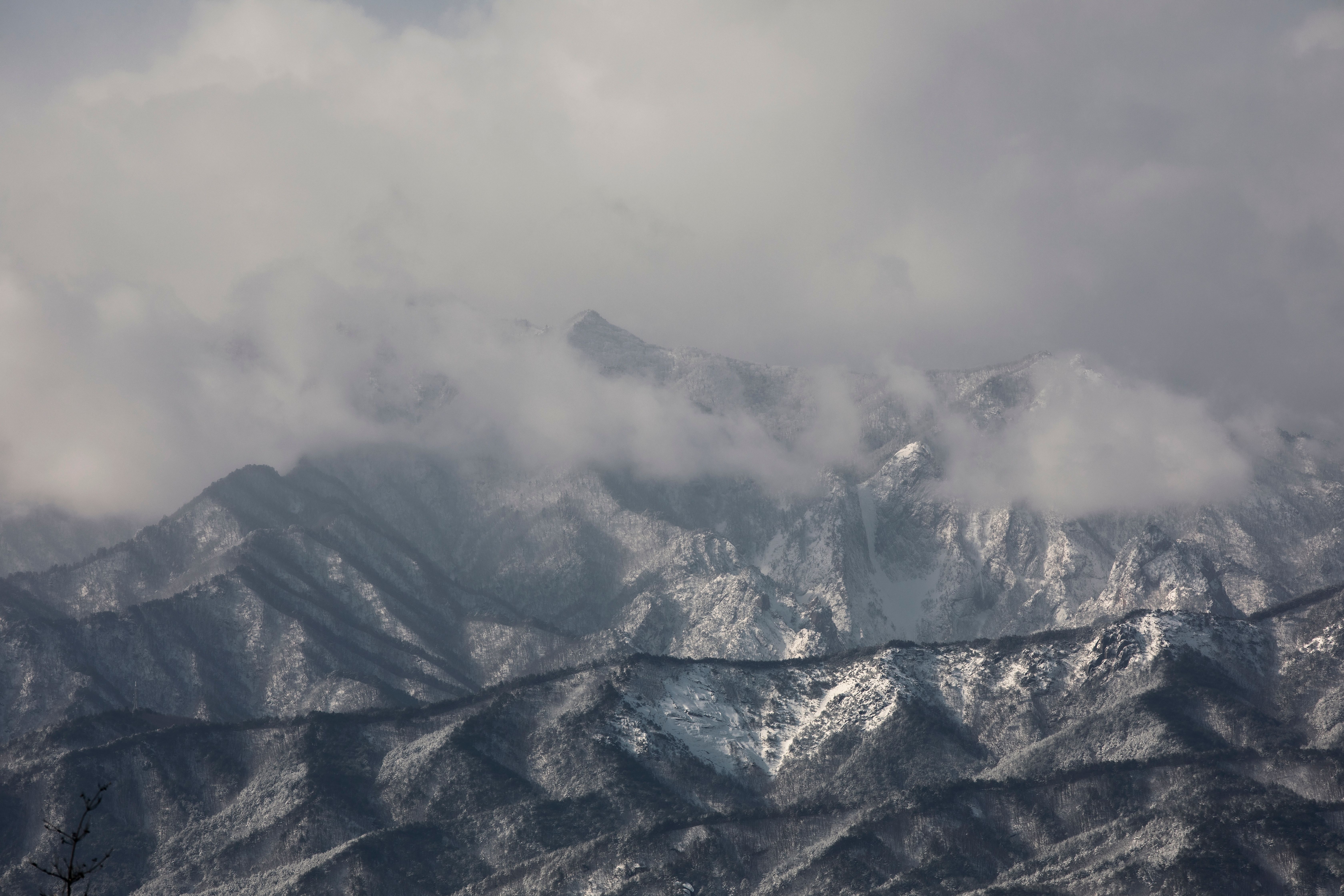 Snow-Covered Mountain Peaks in Misty Clouds · Free Stock Photo
