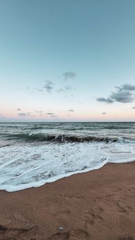 Tranquil beach scene in Mersin, Türkiye with calm waves and soft sunrise light.