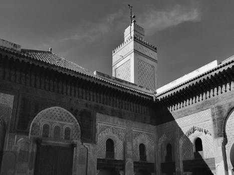 Black and white capture of traditional Moroccan structure, showcasing detailed Islamic architecture in Fes.