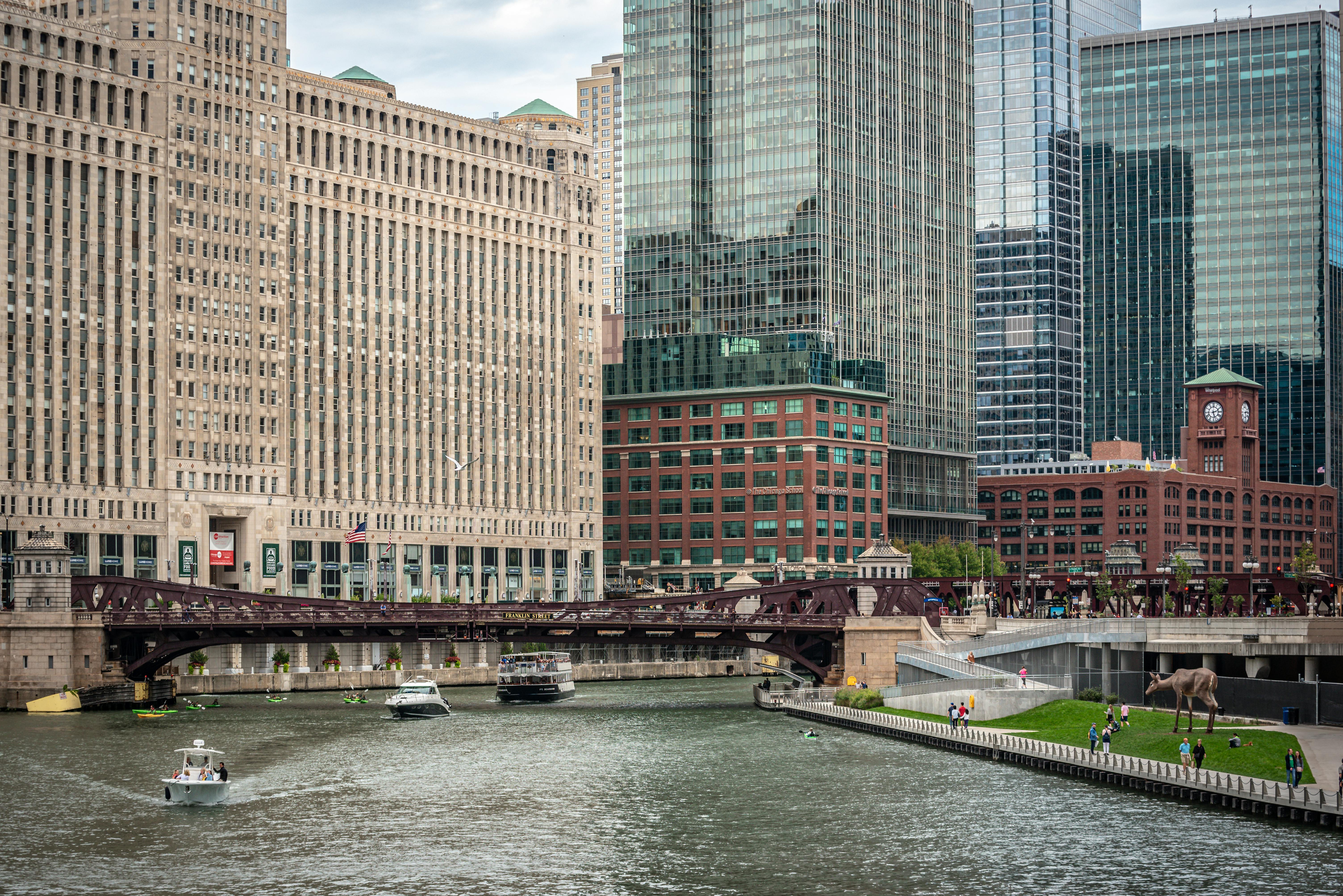 Chicago Riverwalk with skyscrapers in the background - luxury apartments near chicago il