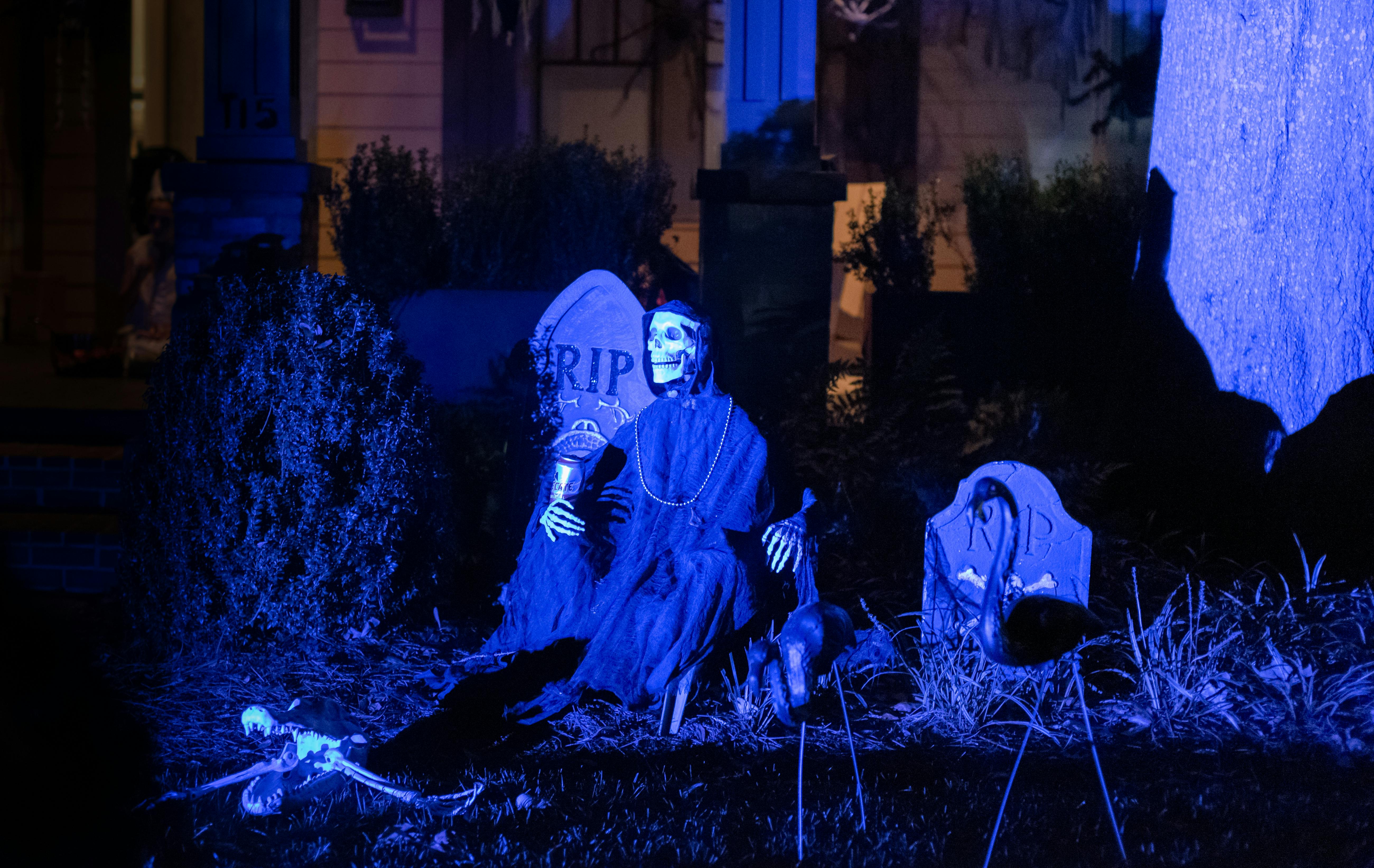 A chilling scene of Halloween decorations featuring skeletons and tombstones in Atlanta, Georgia.