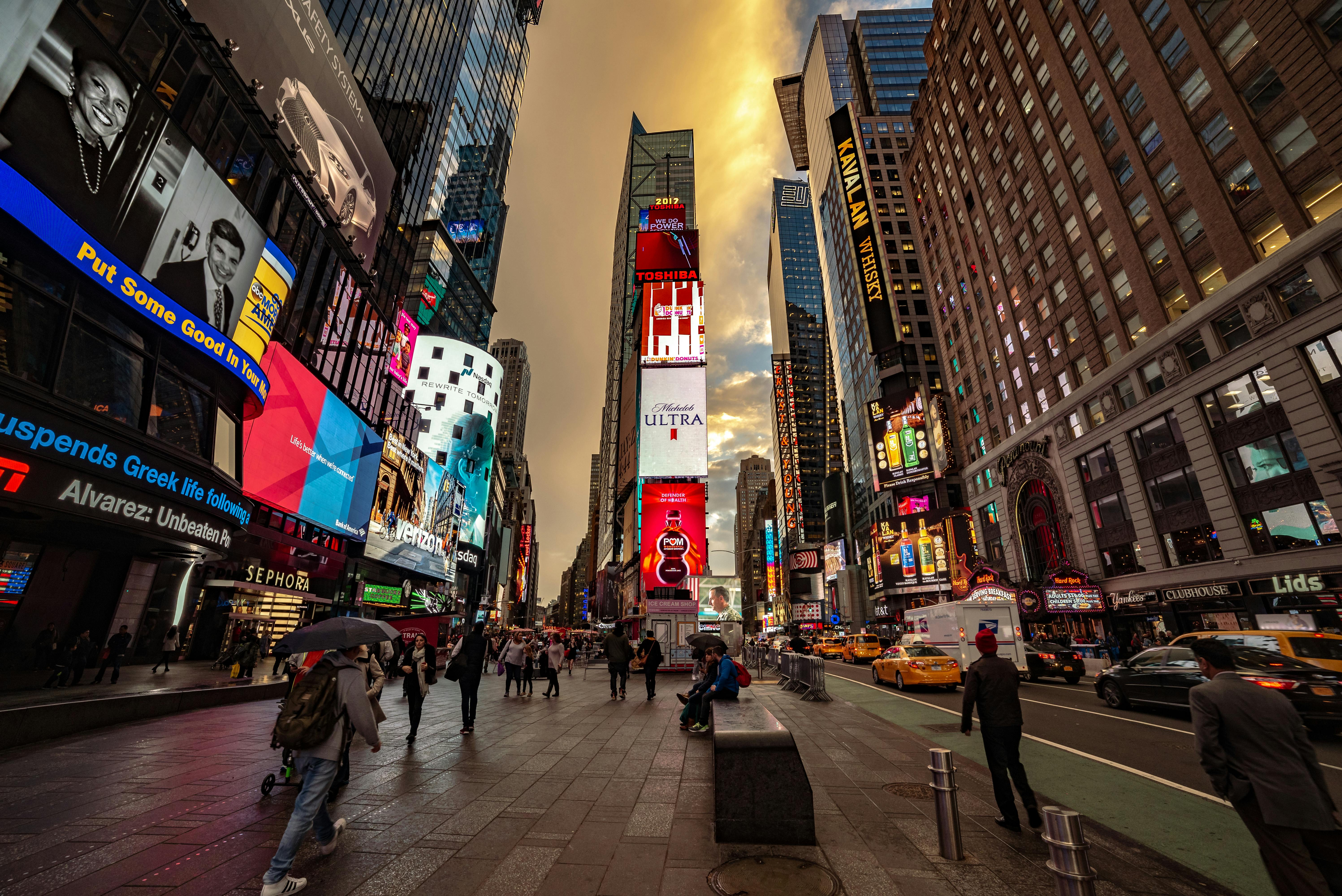 Times Square's iconic lights and bustling atmosphere in New York City at dusk, capturing urban life.