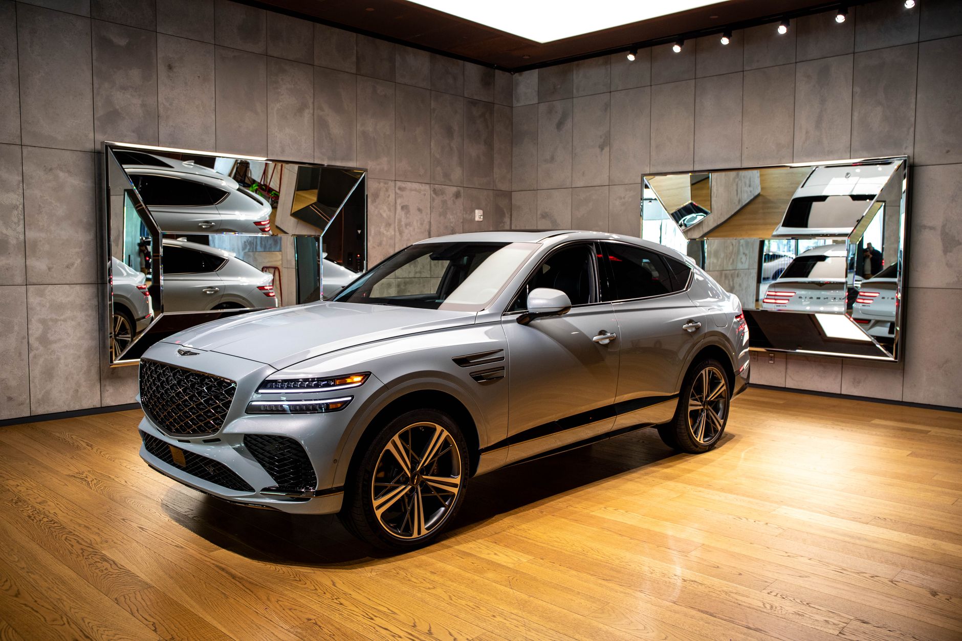 Sleek luxury SUV displayed in a modern indoor car showroom in New York City.
