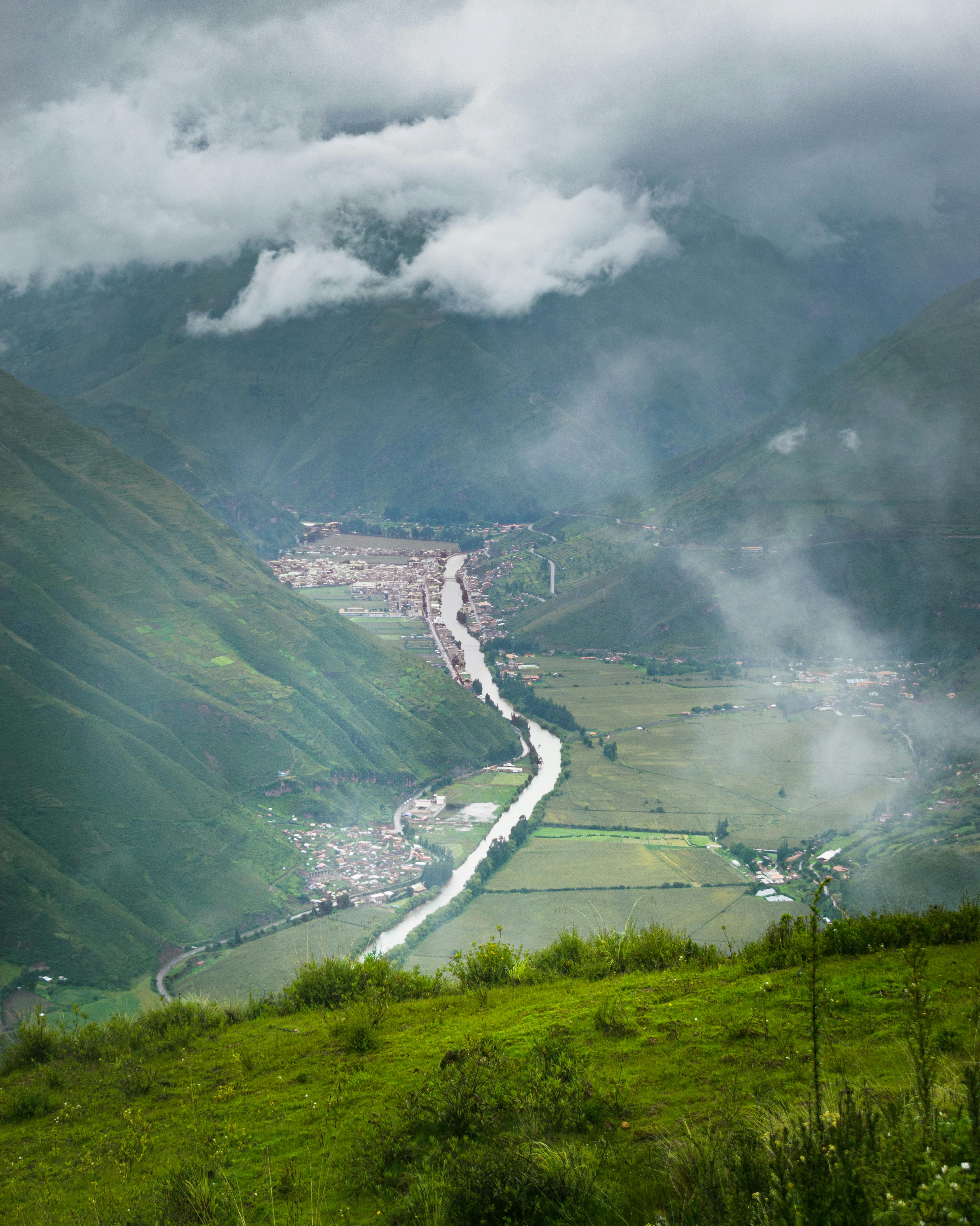 Breathtaking landscape of Cuzco's Sacred Valley with lush greenery and winding river.