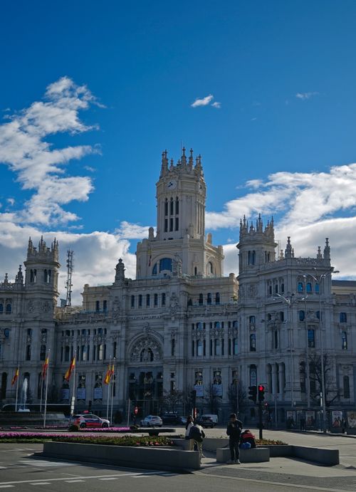 Free Majestic Palacio de Cibeles under a vibrant blue sky in Madrid, showcasing neo-classical architecture. Stock Photo