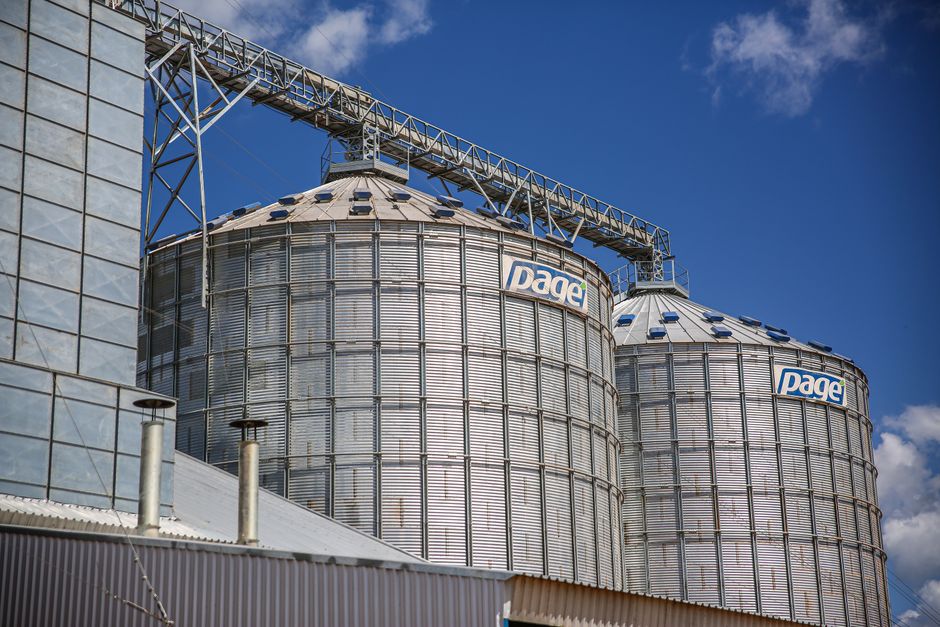 Industrial grain silos in Paragominas, Brazil under a clear blue sky.