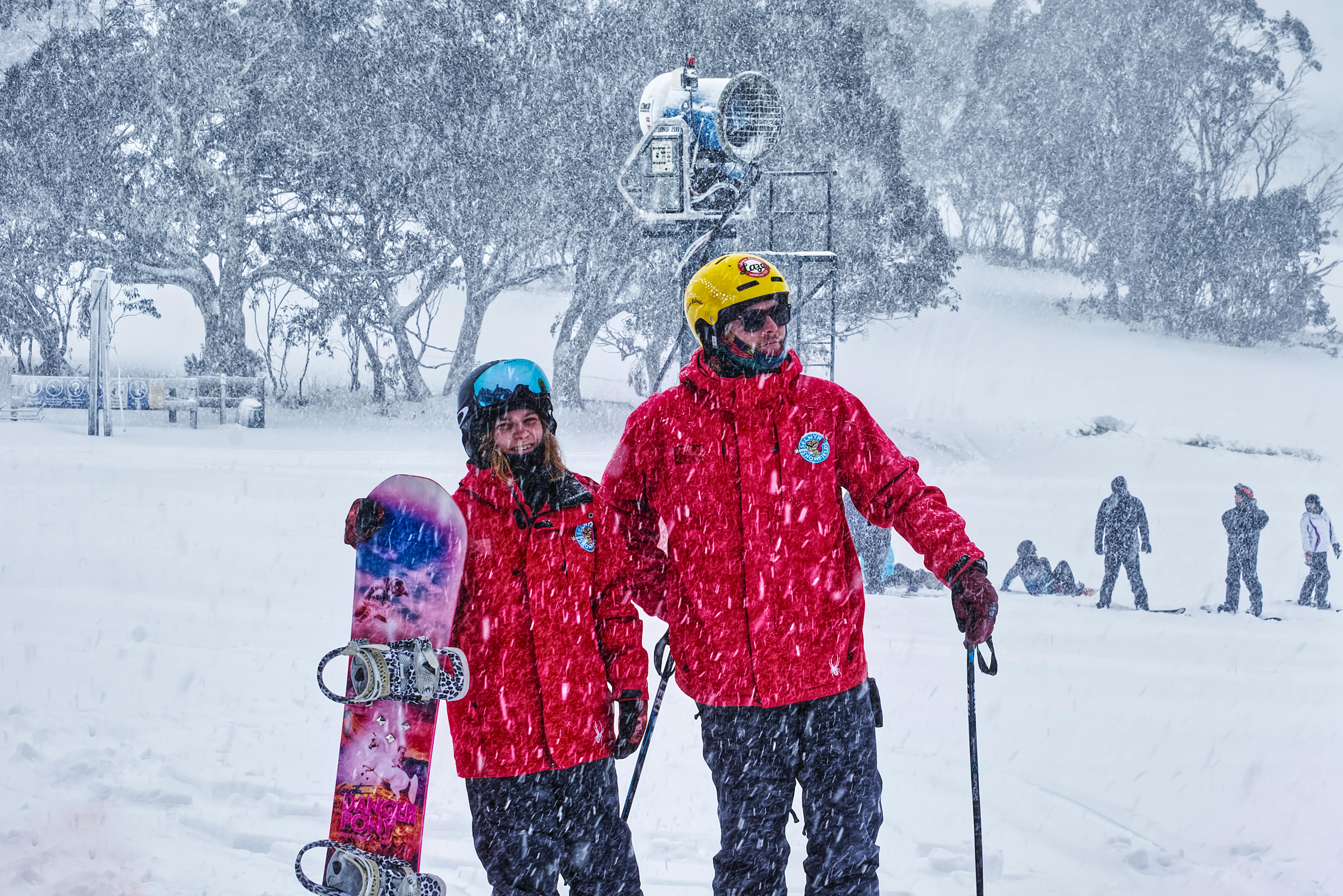 Ski patrol members on duty during a snowy winter day, ensuring safety on the slopes.