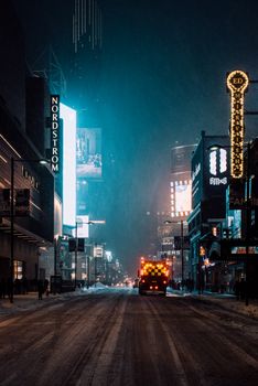 A vibrant night scene of Times Square, New York City, under snowfall with bright neon lights.. pexels, vibrant, night