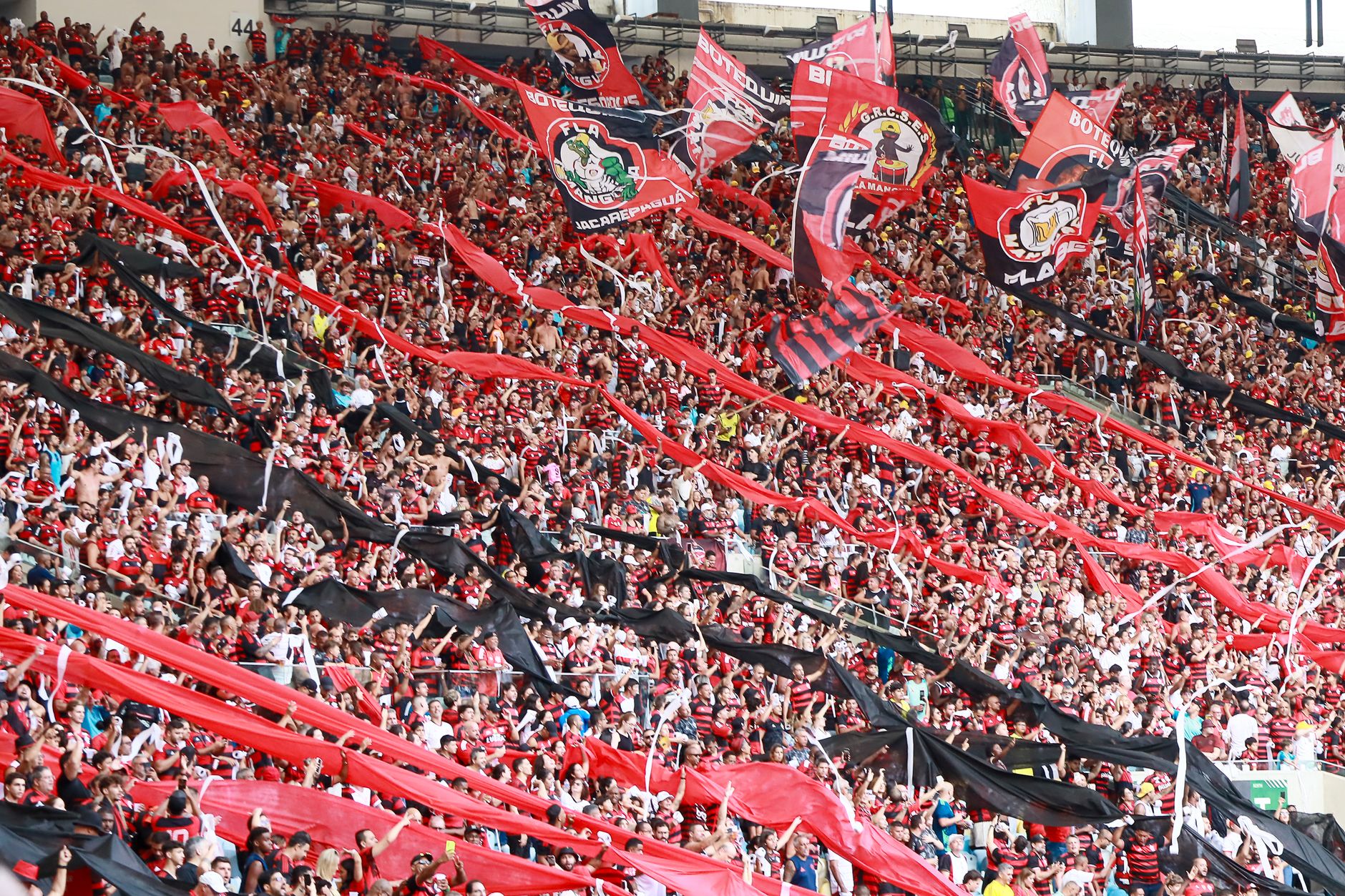 Atlanta supporters in red and black filling Mercedes-Benz Stadium during a dramatic evening football match