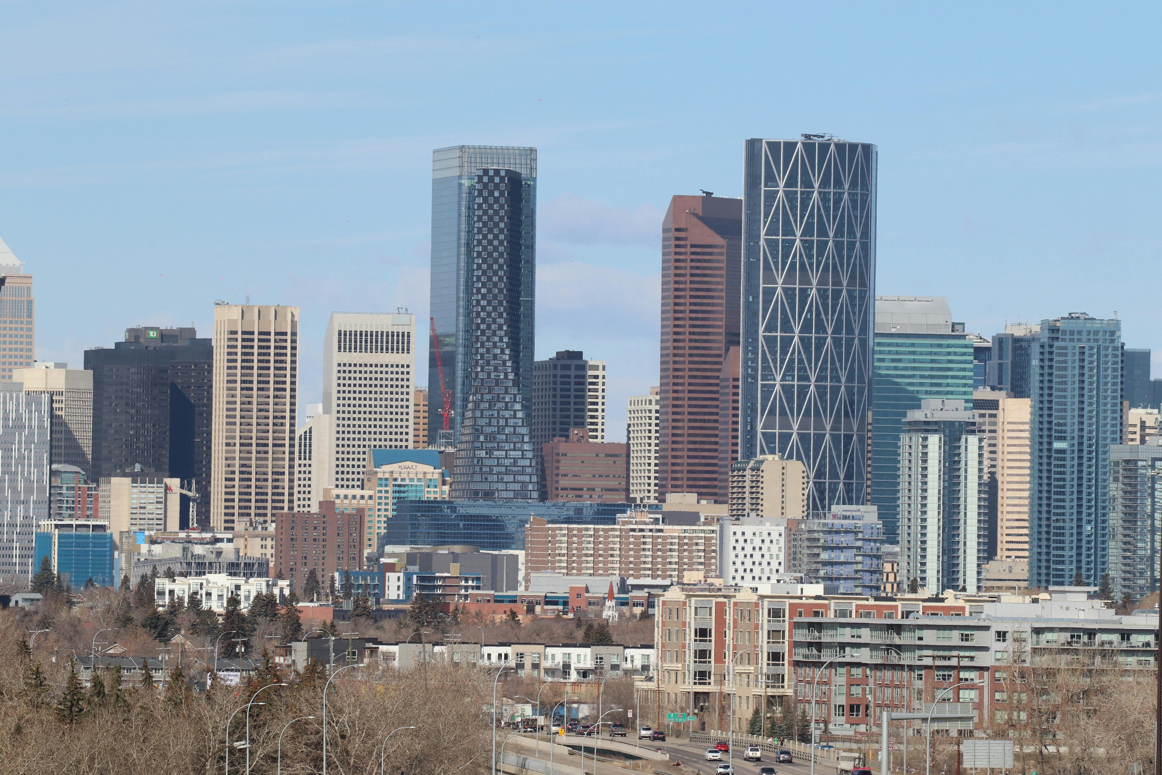 Stunning view of Calgary's modern skyline featuring skyscrapers against a clear sky. - Calgary