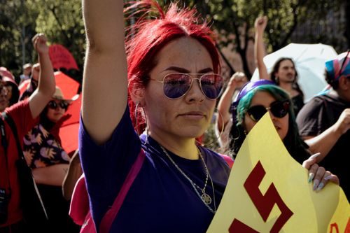 Free Women raising their voices during a vibrant protest in Mexico City for women's rights. Stock Photo
