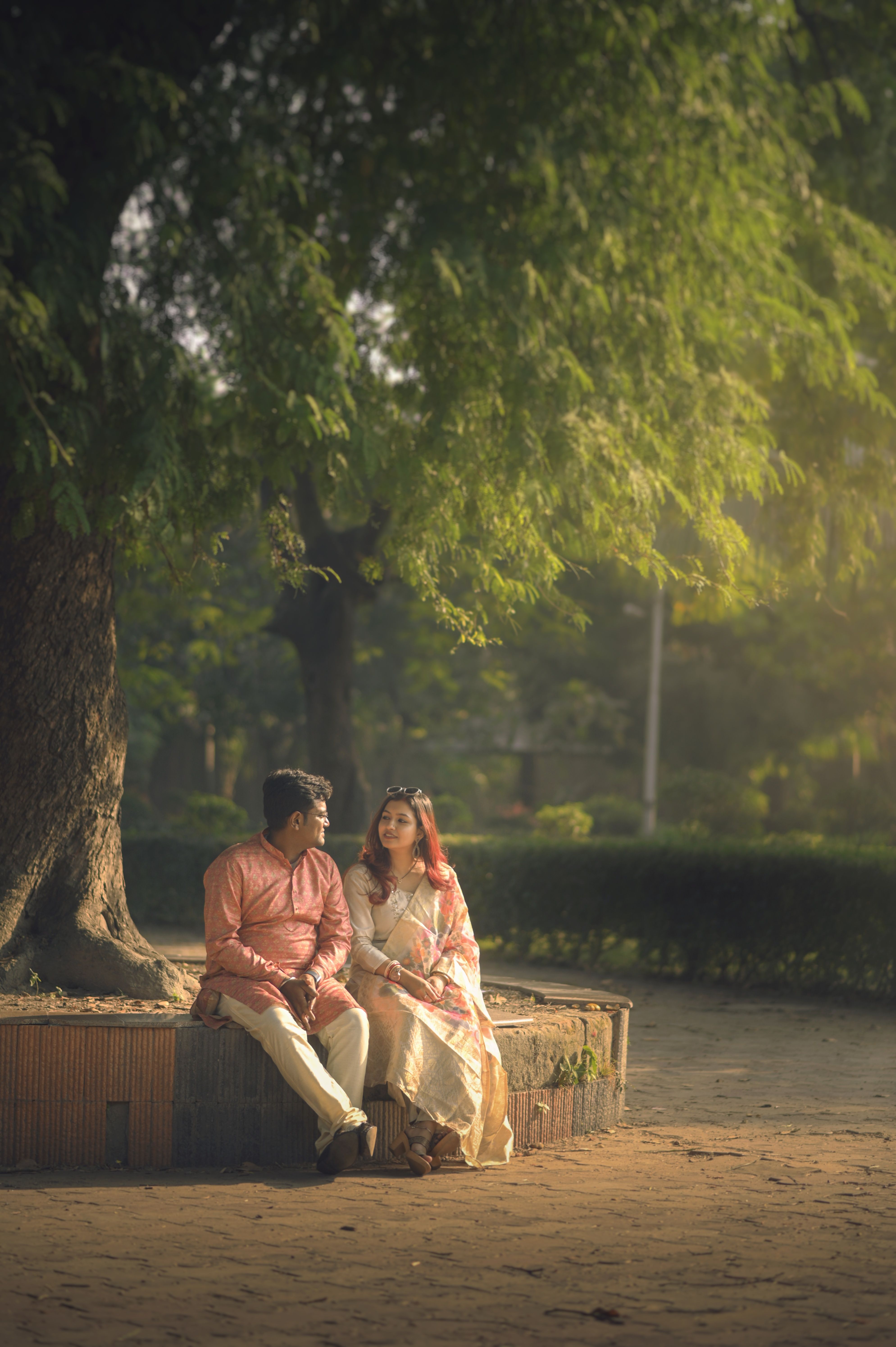 Romantic Couple Sitting Under Tree in Indian Park · Free Stock Photo