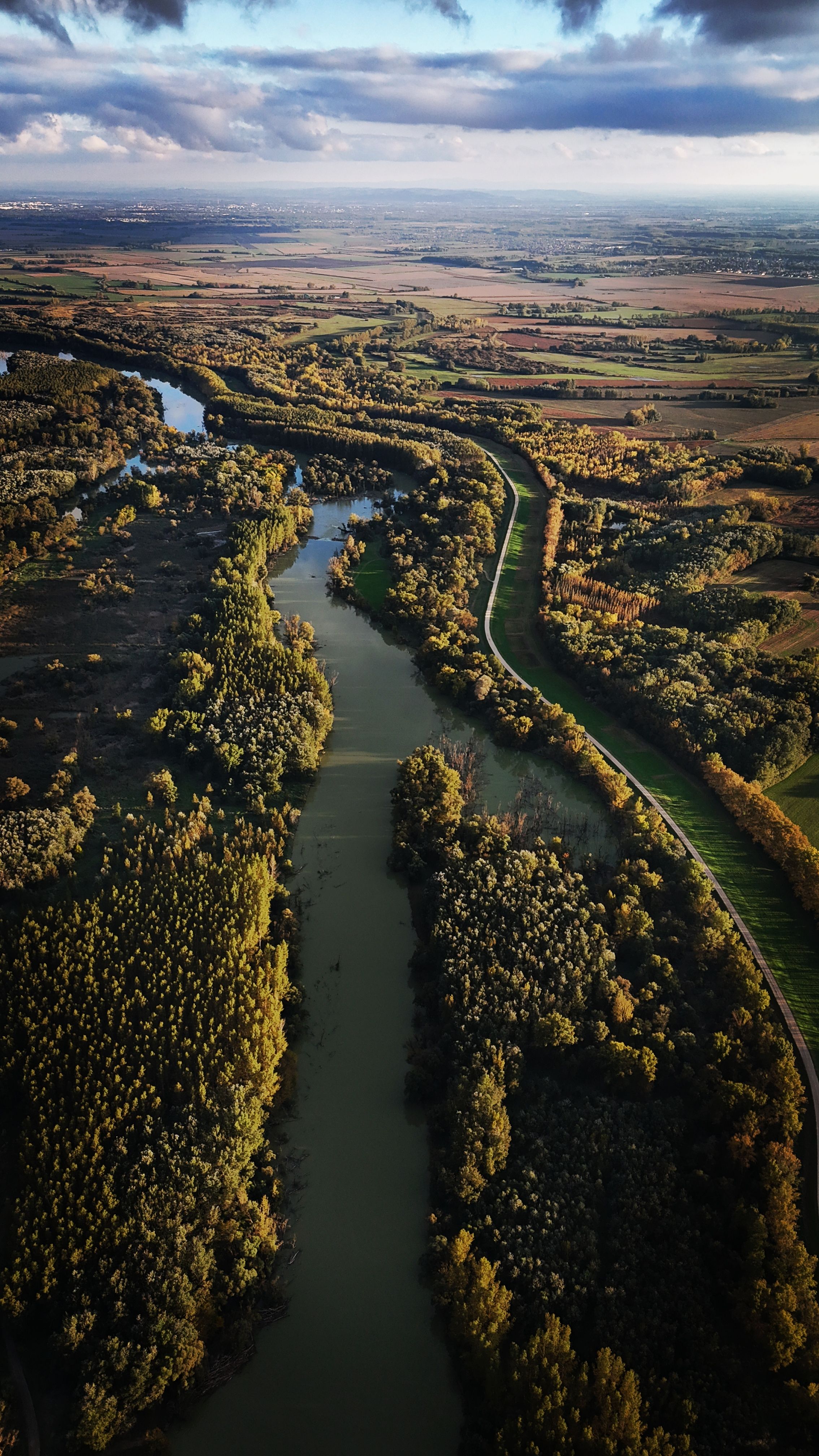 A stunning aerial view showcasing a winding river through lush, autumnal Hungarian landscapes.
