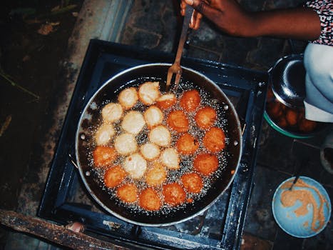 A close-up of Akara being fried outdoors in Kano, Nigeria. Vibrant and culturally rich street food scene.