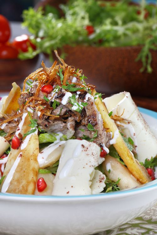 Free Vibrant Middle Eastern fattoush salad topped with pomegranate seeds and crispy vegetables. Stock Photo