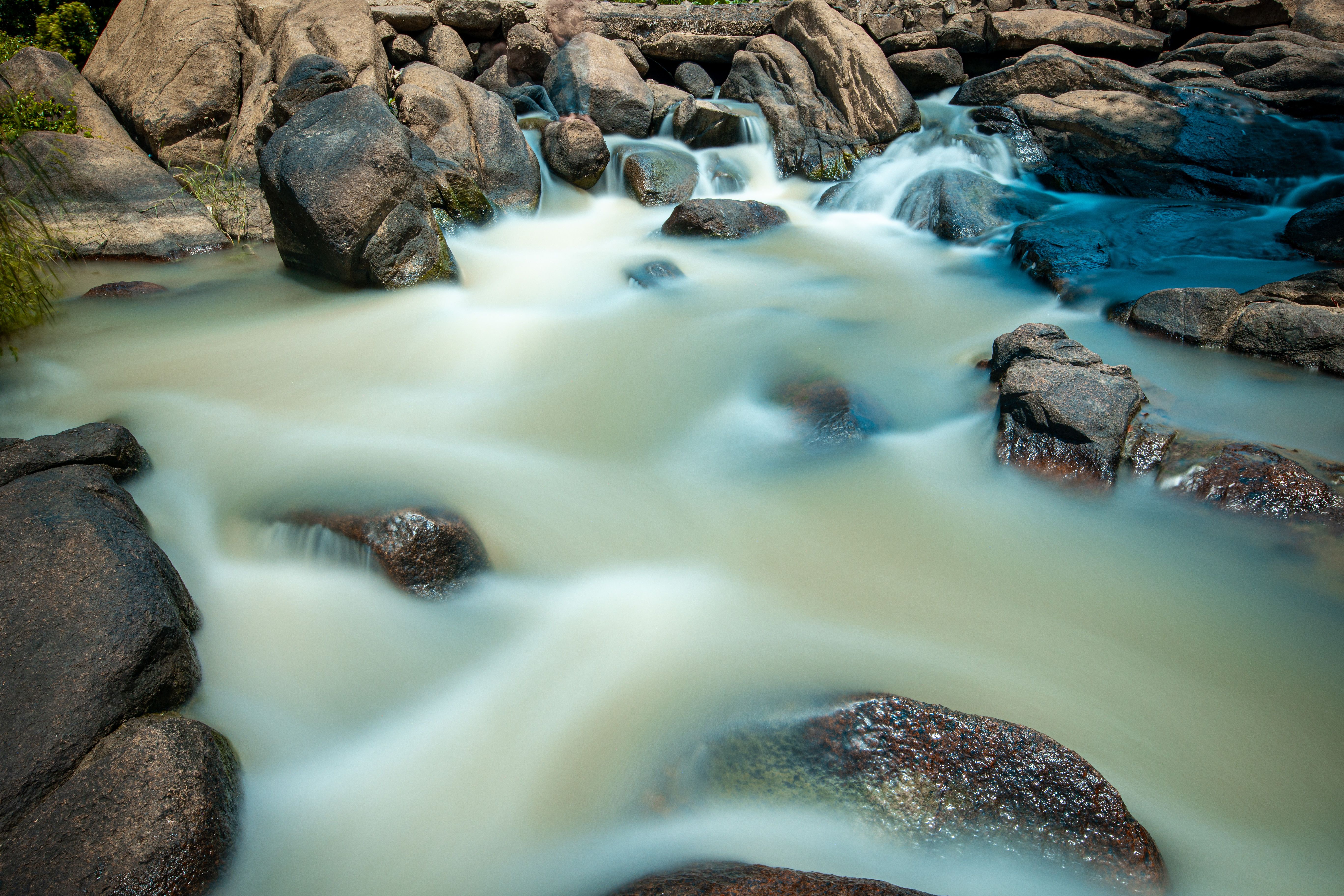 Tranquil Rocky Stream with Gentle Waterfall · Free Stock Photo