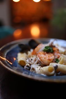 Close-up of seafood pasta with shrimp, mussels, and rigatoni on a plate.