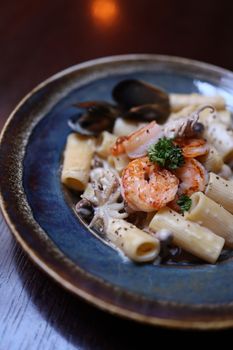 Gourmet seafood pasta featuring shrimp and mussels in a creamy sauce.