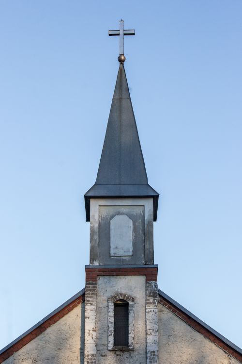 Free A classic church steeple with a cross, photographed against a clear blue sky. Stock Photo