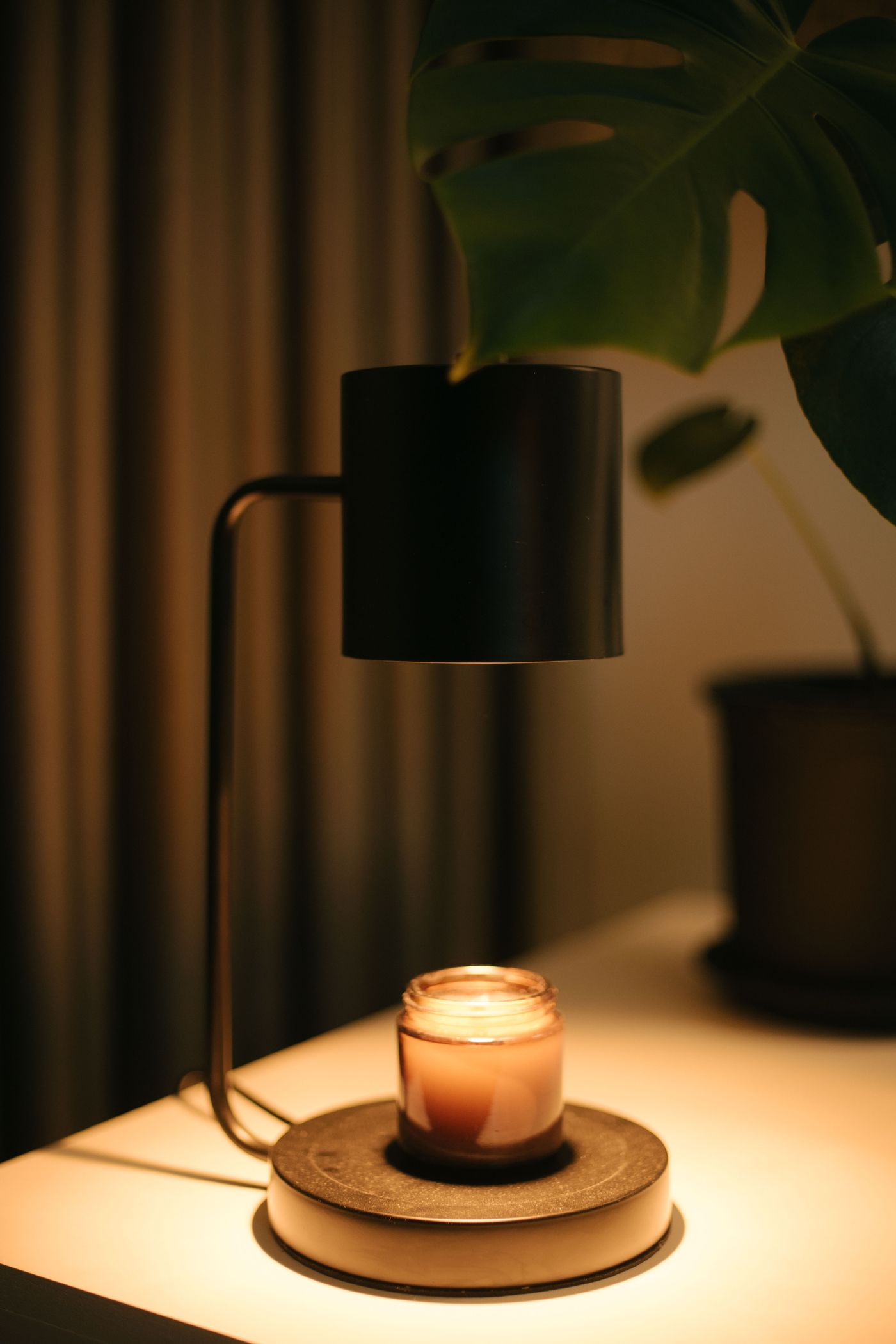 A lamp and candle create a warm, inviting glow.