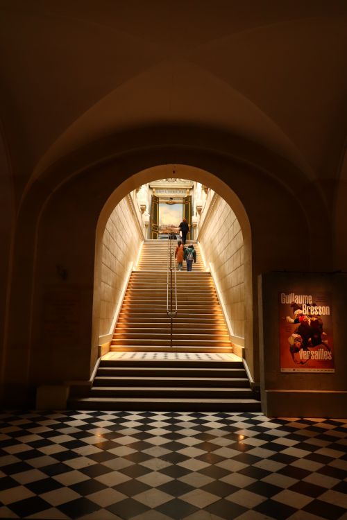 Free A grand, beautifully lit indoor staircase inside Versailles Palace. Stock Photo
