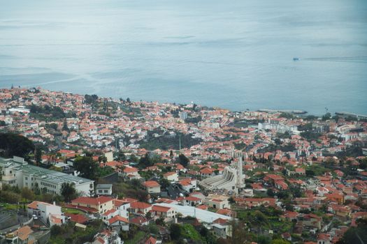 Stunning aerial view of Funchal, Madeira Island showcasing red rooftops by the sea.