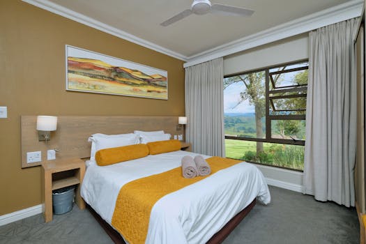 Modern bedroom interior with a scenic view, featuring cozy decor, warm tones, and elegant design elements.