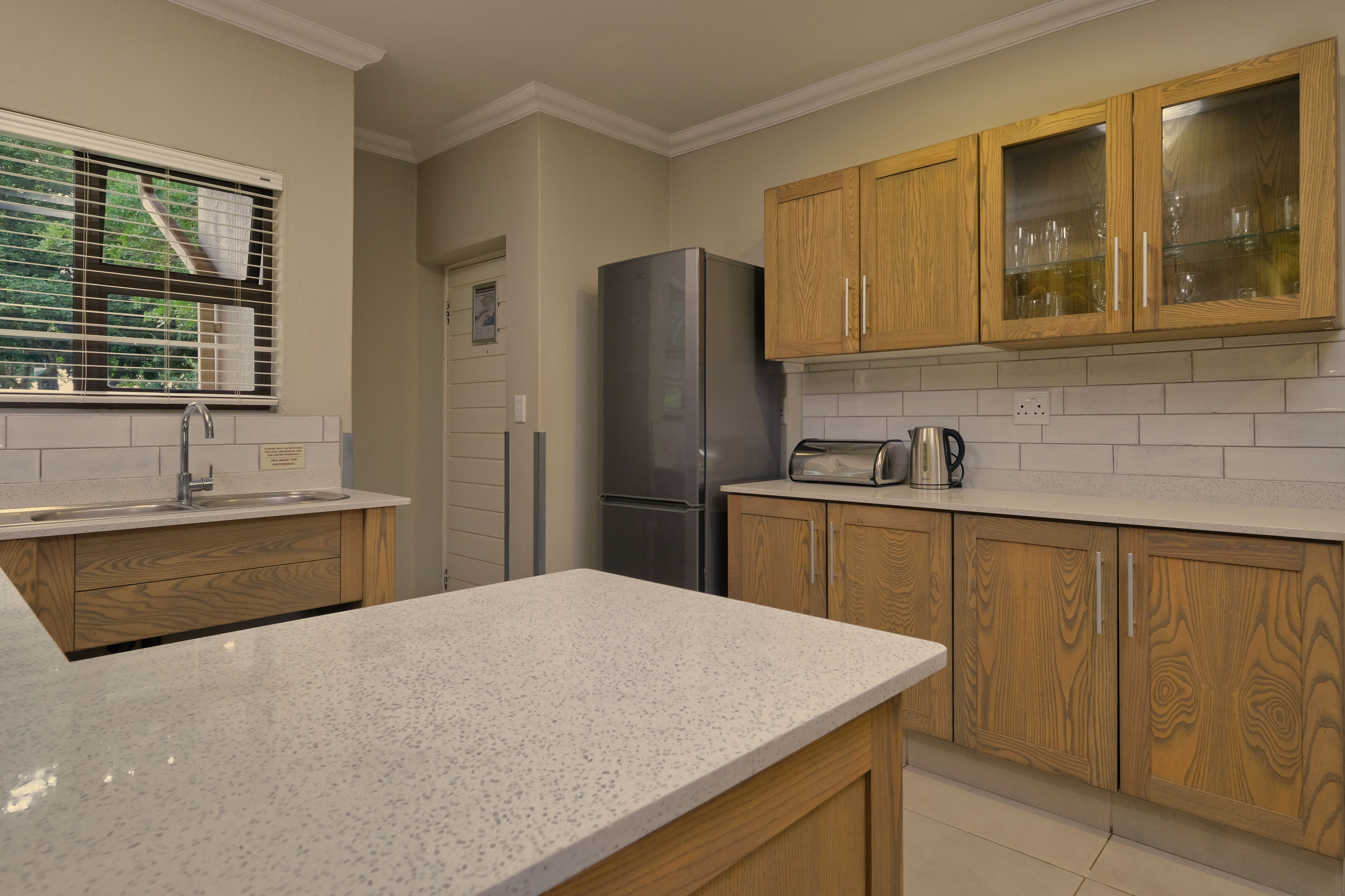 Free Stylish kitchen interior featuring wooden cabinetry and modern appliances. Stock Photo