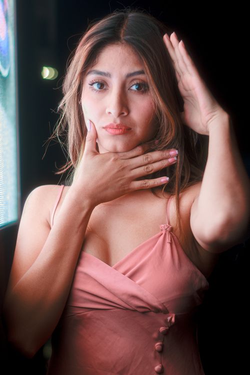 Free Stylish portrait of an adult woman indoors with artistic lighting and pose. Stock Photo