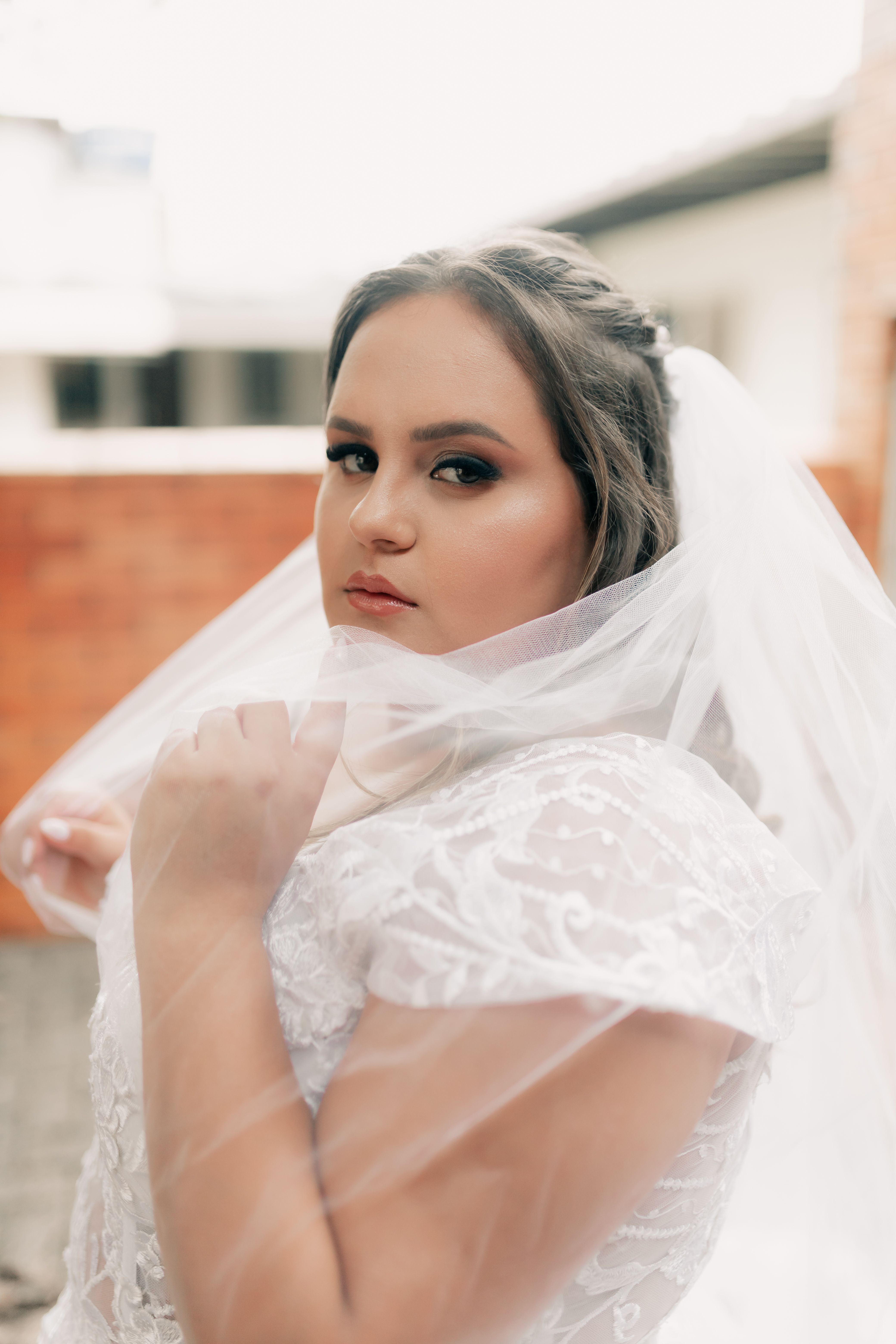Elegant Bride in Lace Dress with Veil Outdoors · Free Stock Photo
