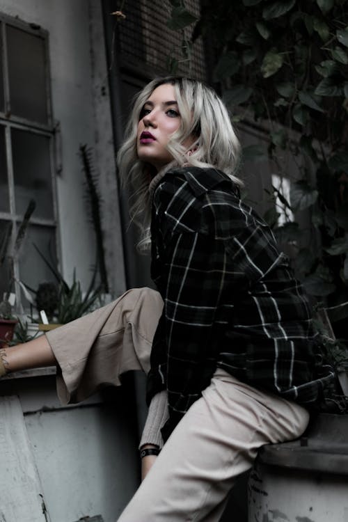 Free Woman in Black and White Checkered Dress Shirt Sitting on Gray Concrete Bench Stock Photo