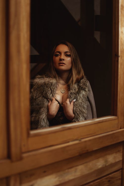 Woman Standing Beside Window