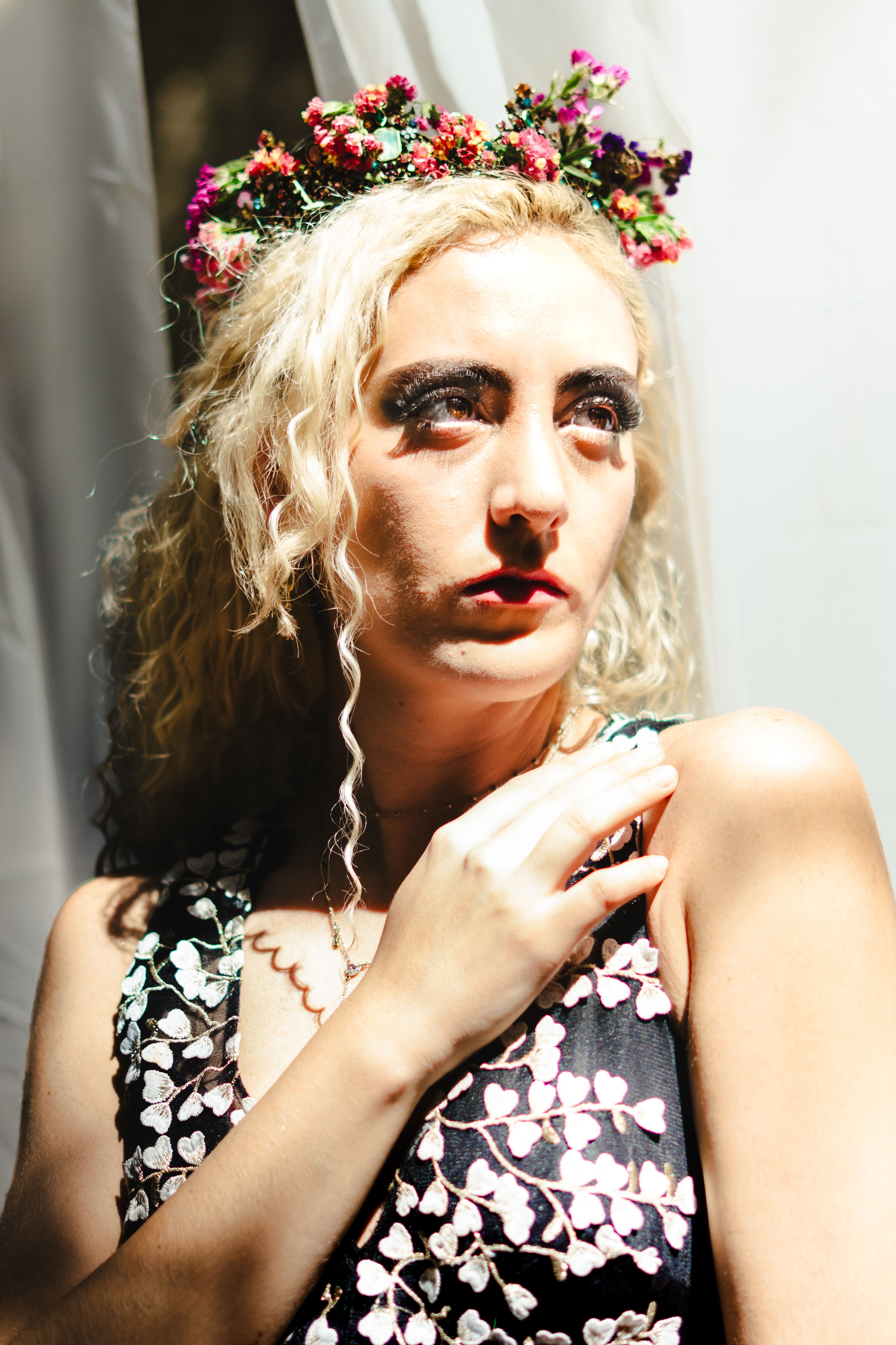 Elegant Woman with Floral Headpiece in Sunlit Portrait · Free Stock Photo