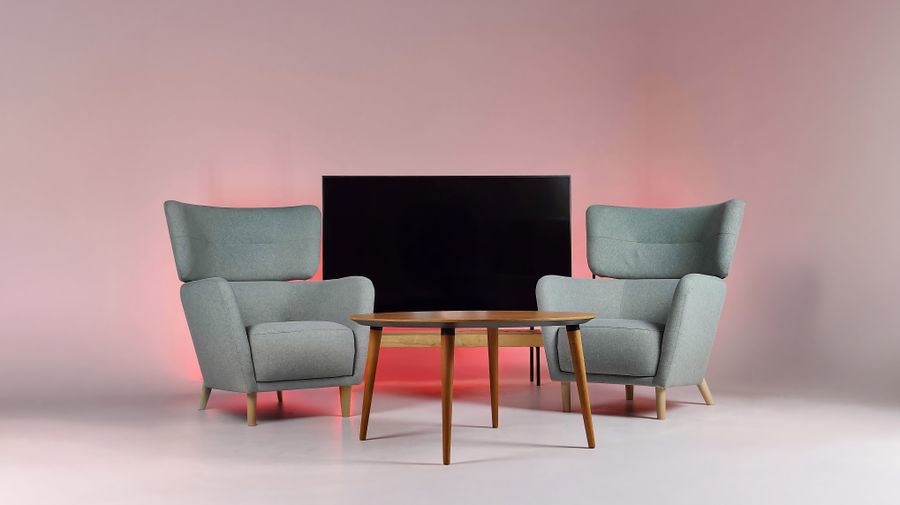 Two armchairs and a low table in a lit studio room, photo by Manuel Campagnoli on Pexels