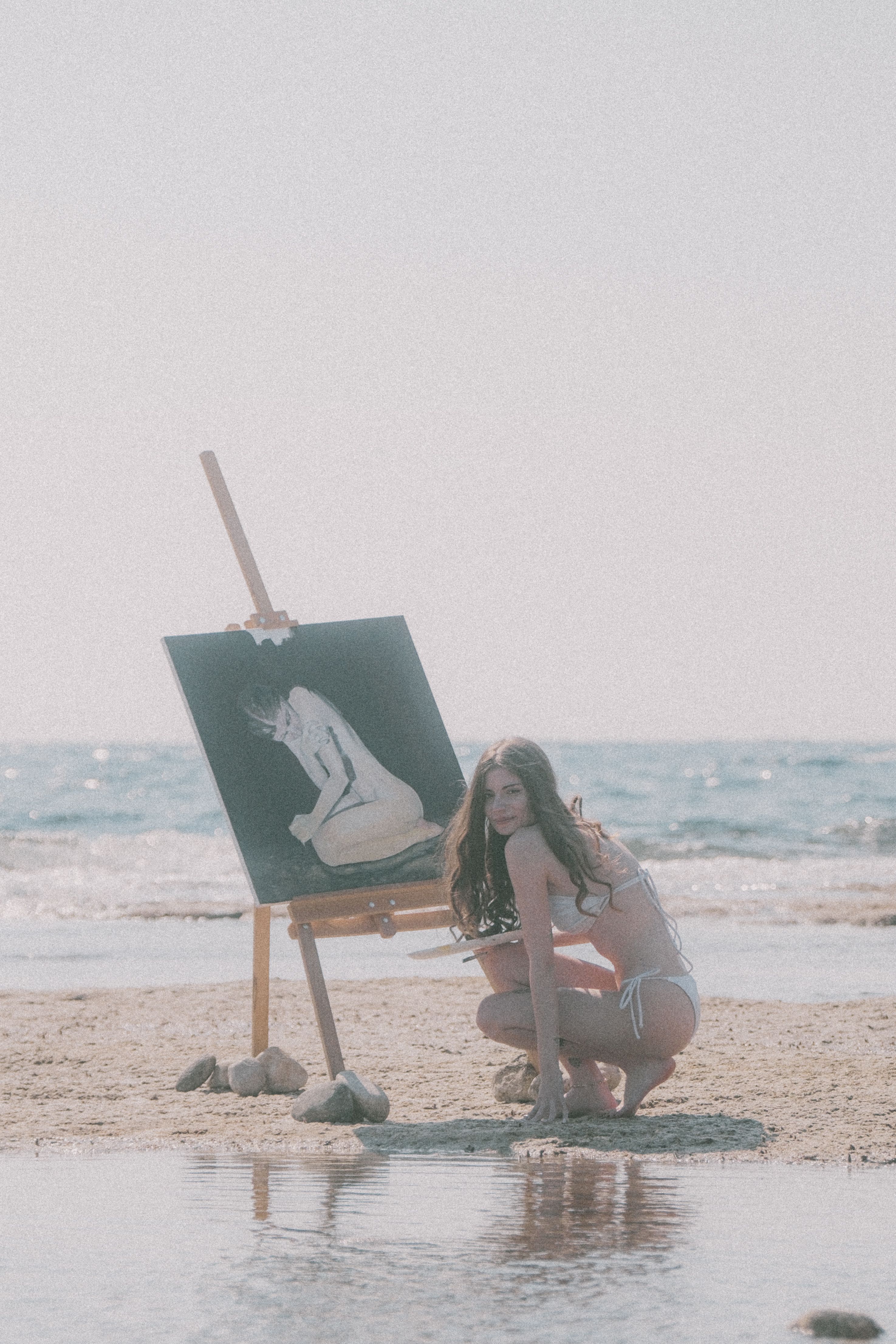 Woman Painting by the Ocean on a Sunny Beach · Free Stock Photo
