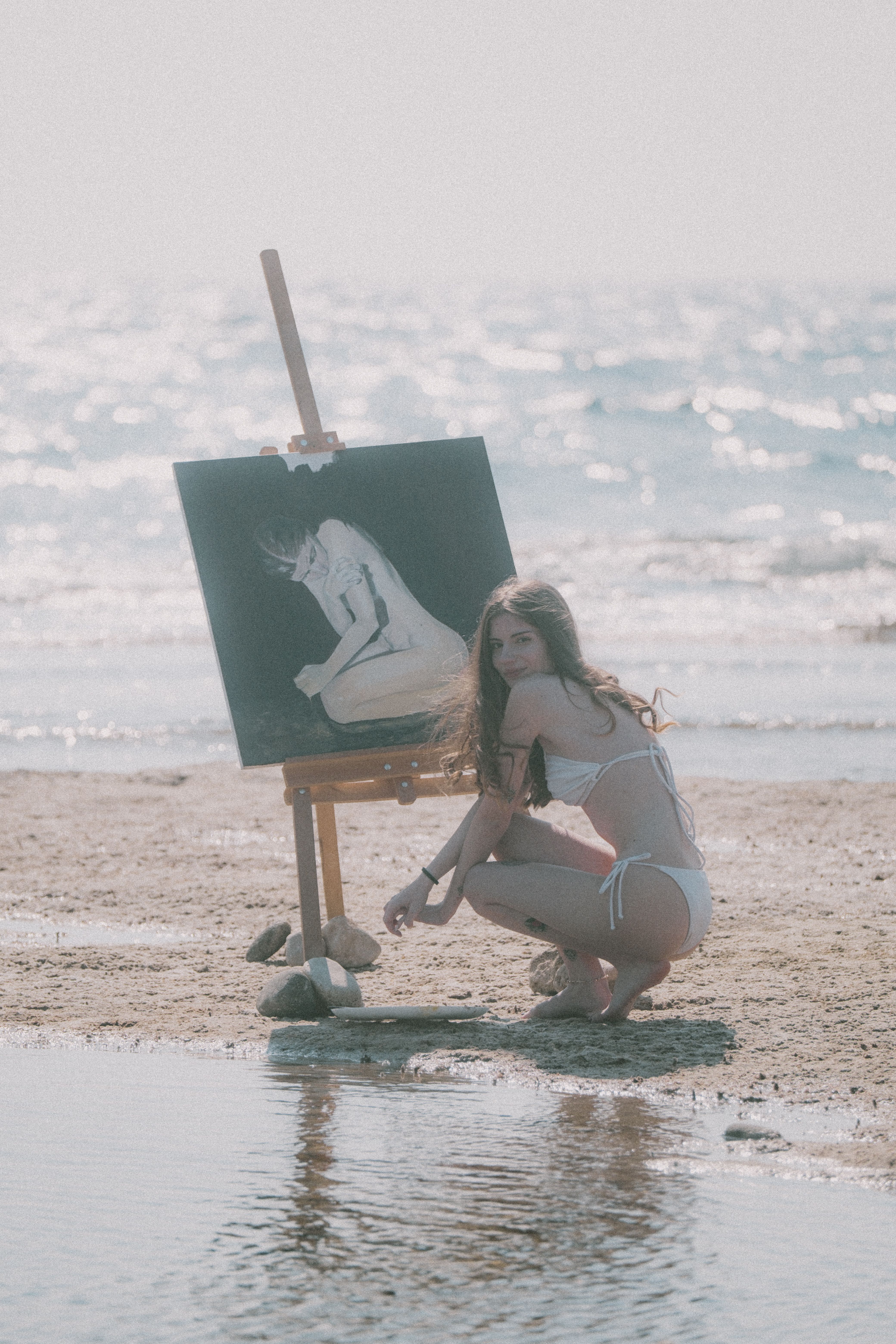 Woman Painting on a Beach with Sunlit Ocean · Free Stock Photo