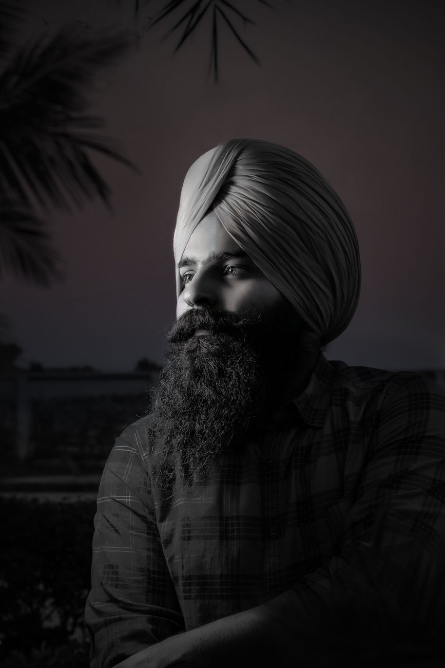 Dramatic black and white portrait of a man with a full beard and turban looking away.. pexels, dramatic, black