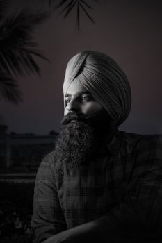 Dramatic black and white portrait of a man with a full beard and turban looking away.. pexels, dramatic, black