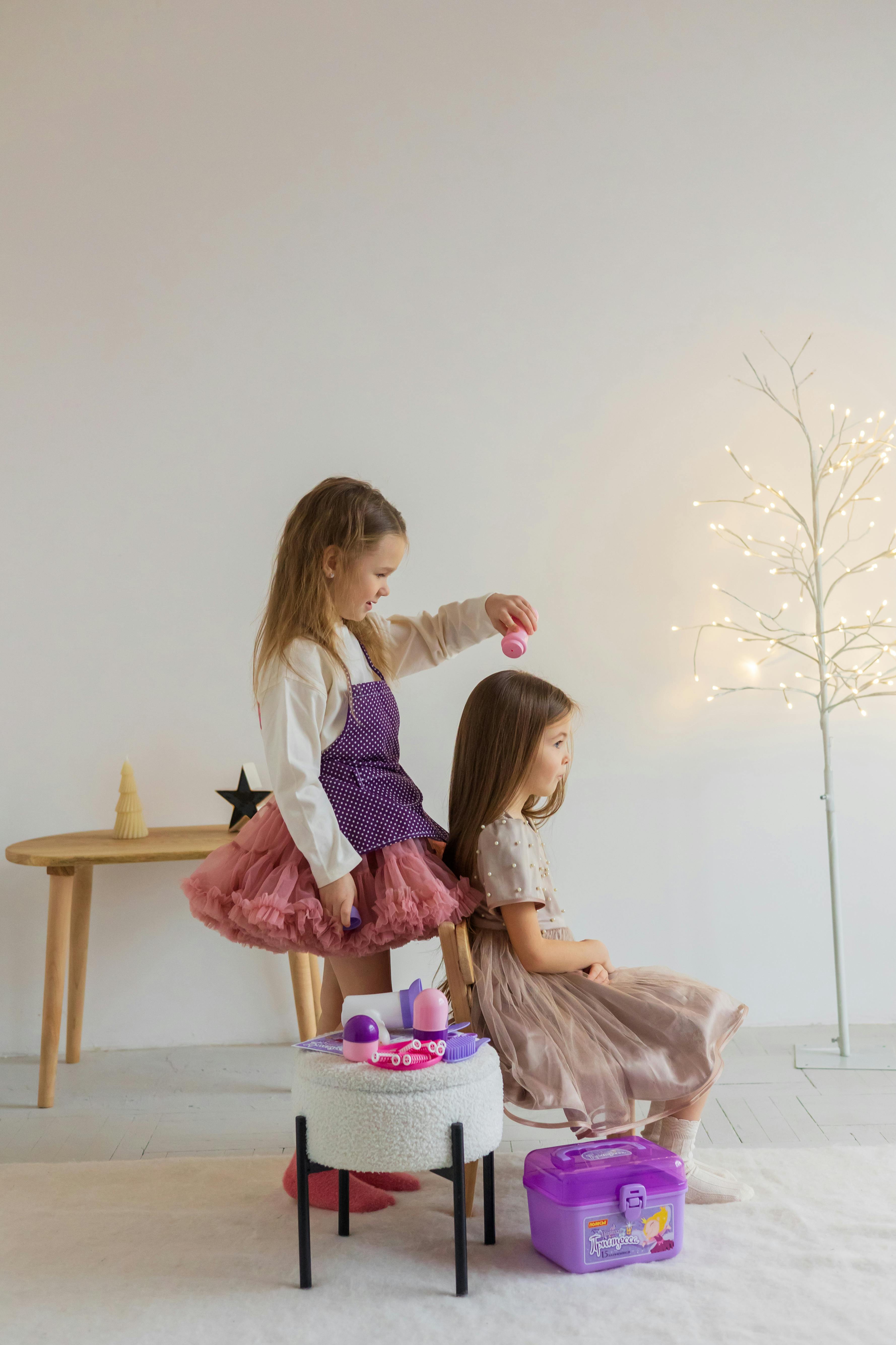 A toddler girl playing with toys in a brightly lit room