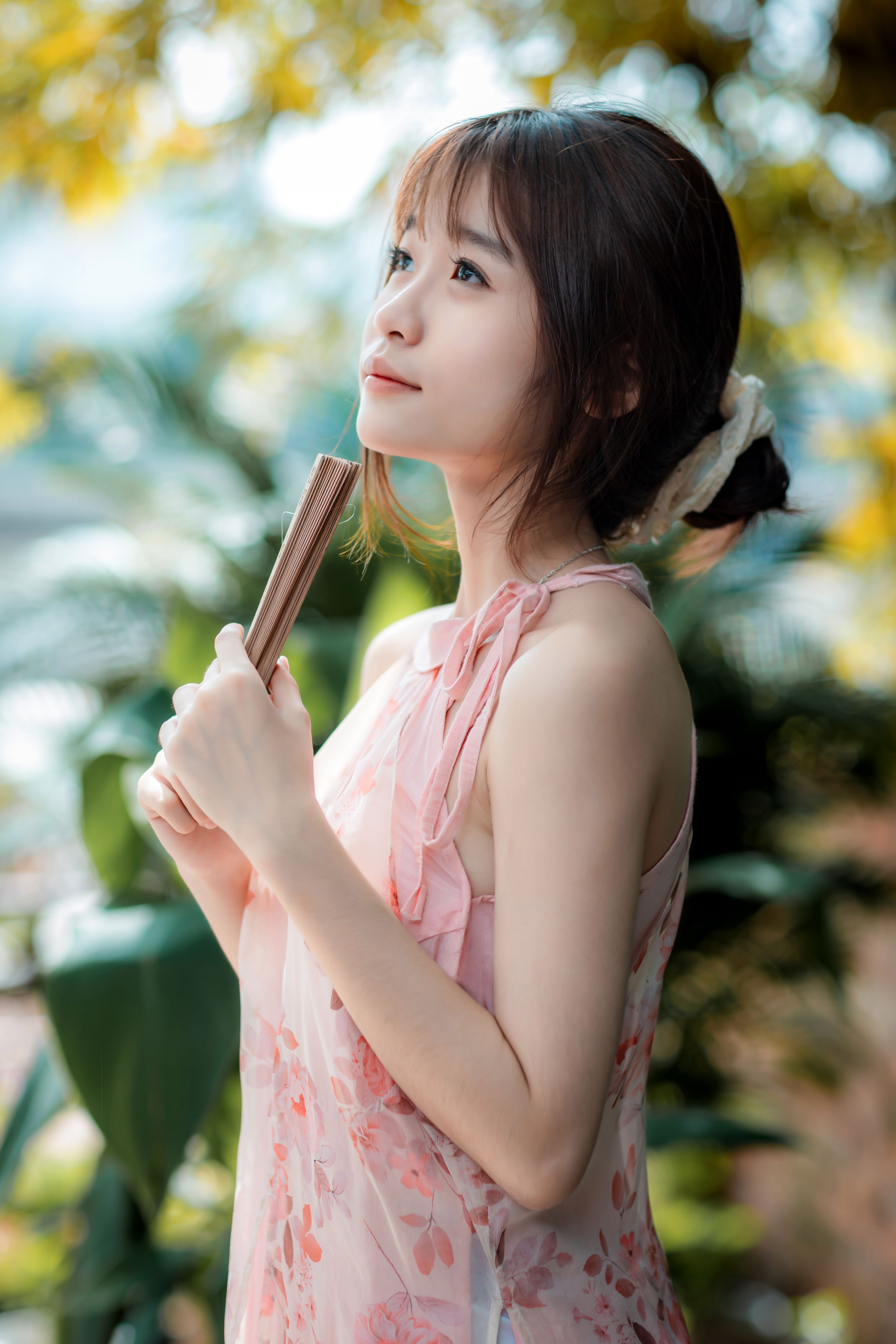 Young Woman Posing Outdoors in Floral Dress · Free Stock Photo