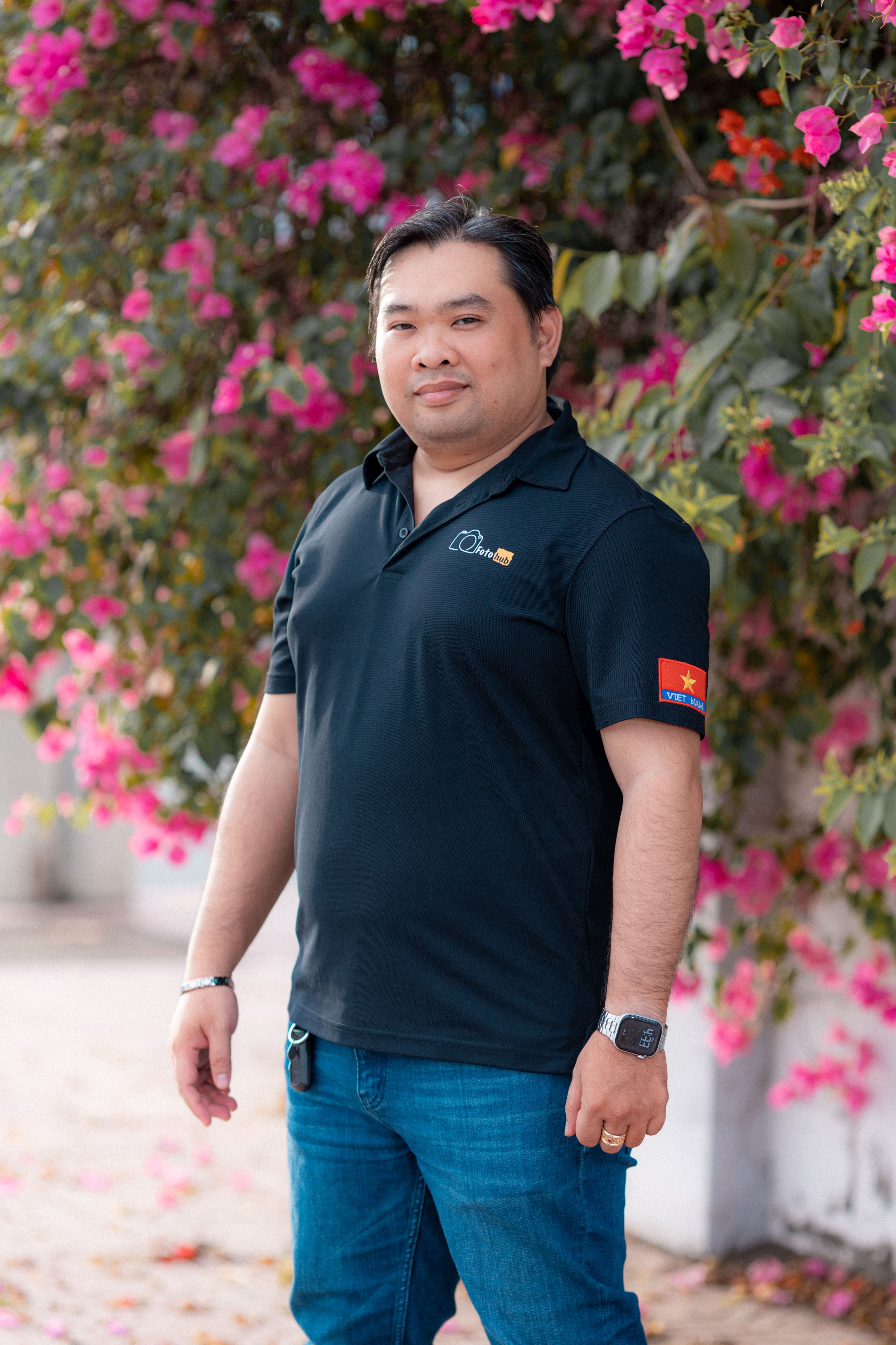 Portrait of a Man in Front of Vibrant Flowers · Free Stock Photo