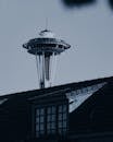 西雅图太空针塔的戏剧性景观部分被屋顶遮挡，天空阴沉