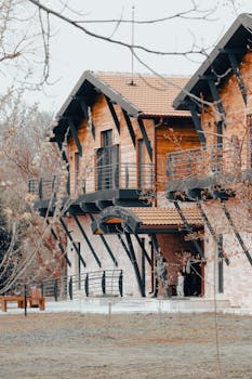 Stunning modern wooden house exterior featuring large windows and a tiled roof, showcasing elegant design.