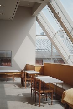 Bright, modern dining area with natural light streaming from large windows creating a cozy atmosphere.