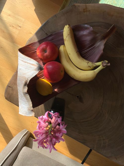 Free Aerial view of tropical fruits on a wooden table with a hyacinth flower. Stock Photo