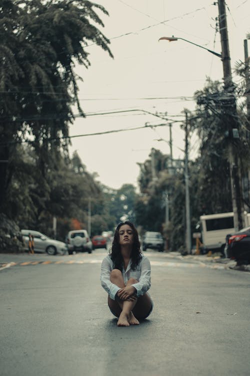 Free Woman Sitting on Road Stock Photo