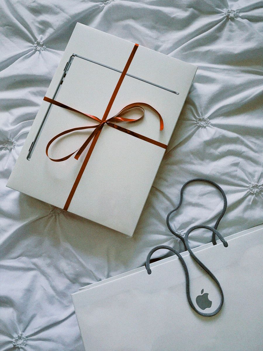 Wrapped sealed Apple gift package on elegant bedding ready for buyback Chicago