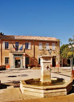 Beautiful water fountain in the sunny village square of La Mole, Provence-Alpes-Côte d'Azur, France.