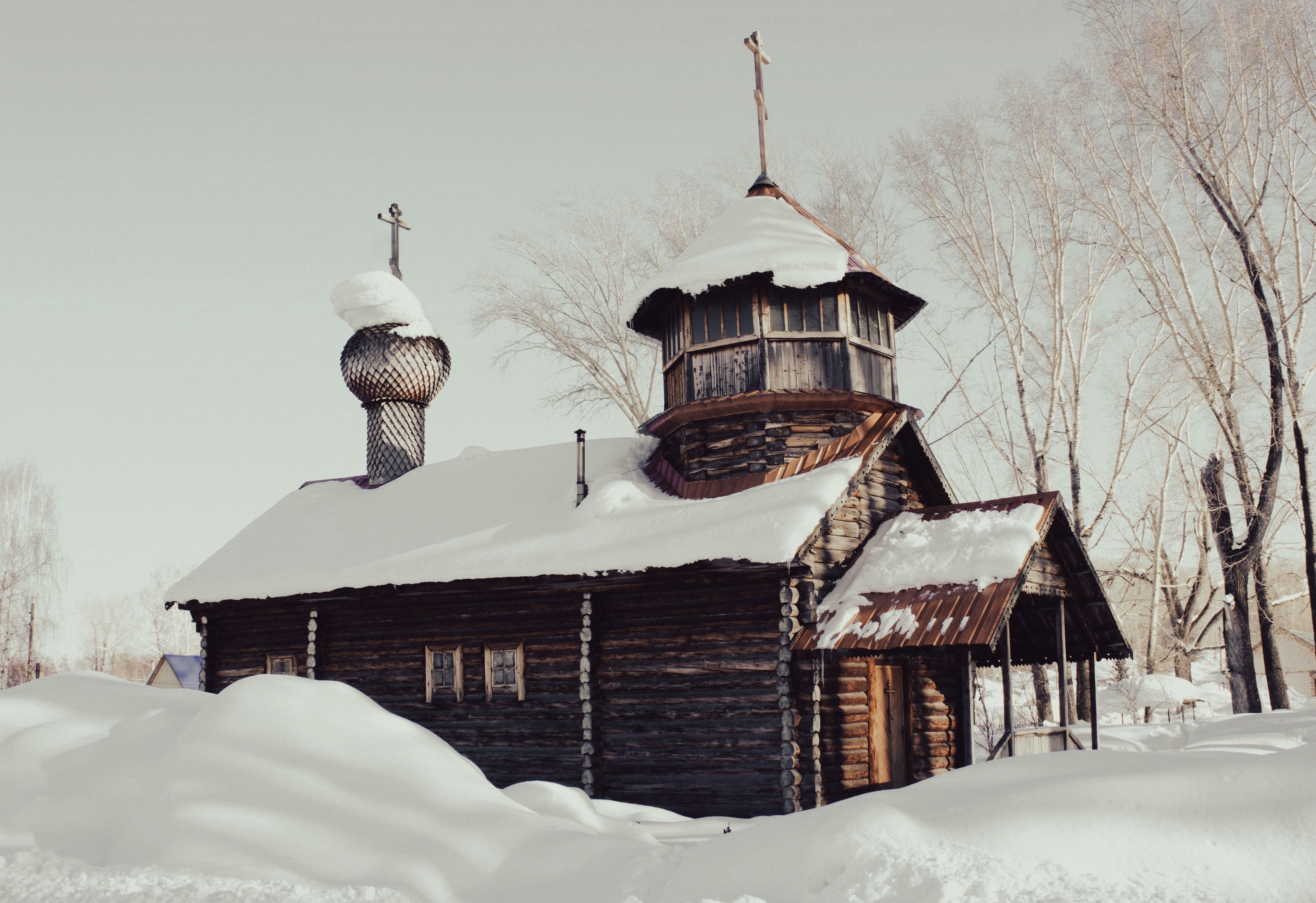 Snow-Covered Wooden Church in Winter Landscape · Free Stock Photo